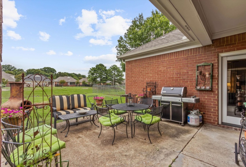 Expansive concrete patio area with a covered extension