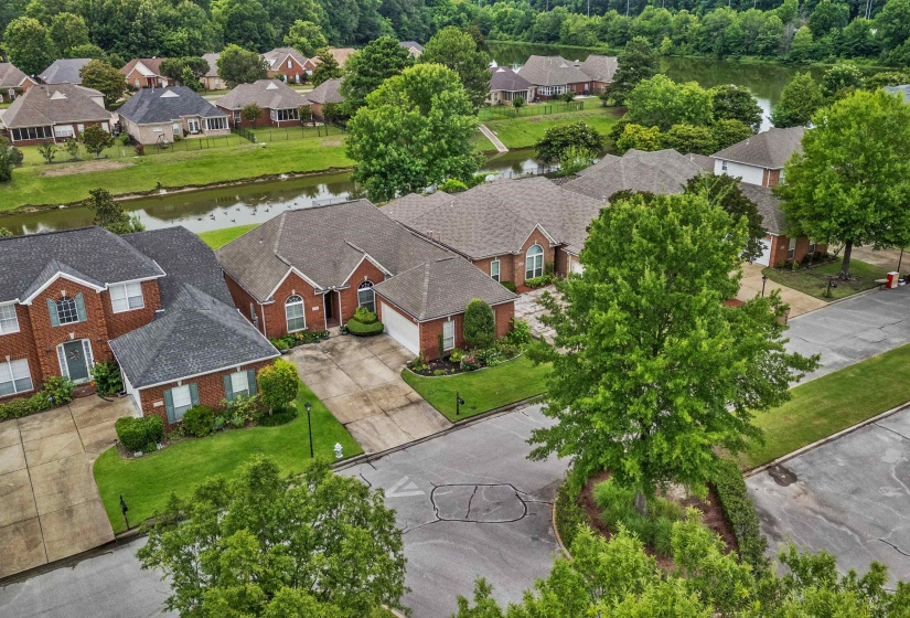 Residential community featuring brick-faced homes with gabled roofs and attached garages