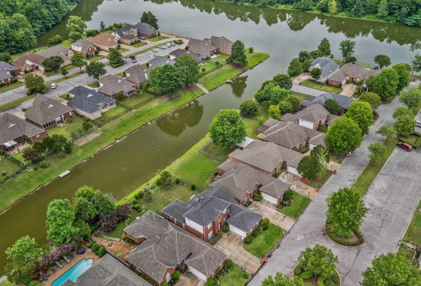 Aerial perspective showcasing a residential community with water frontage