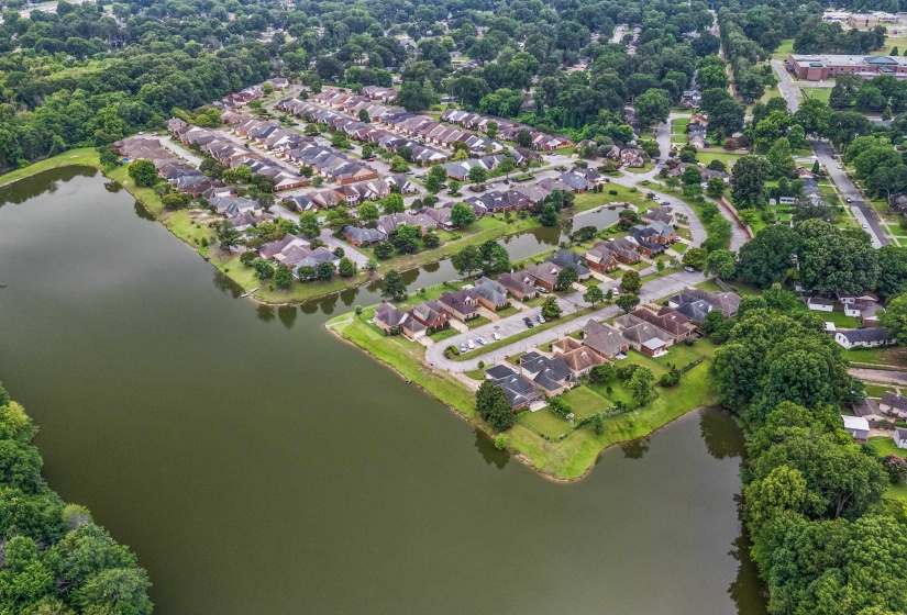 Aerial perspective showcasing a residential area with numerous homes situated alongside a body of water