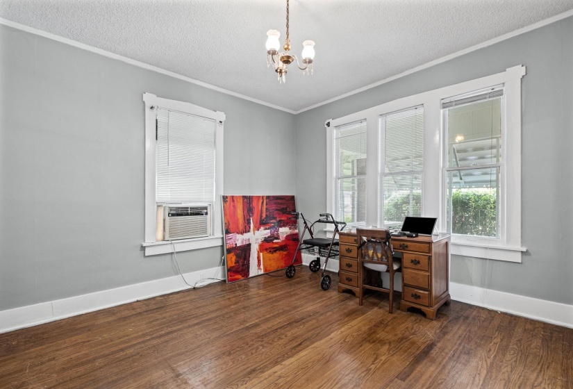 Hardwood flooring throughout, framed by light gray walls and white trim