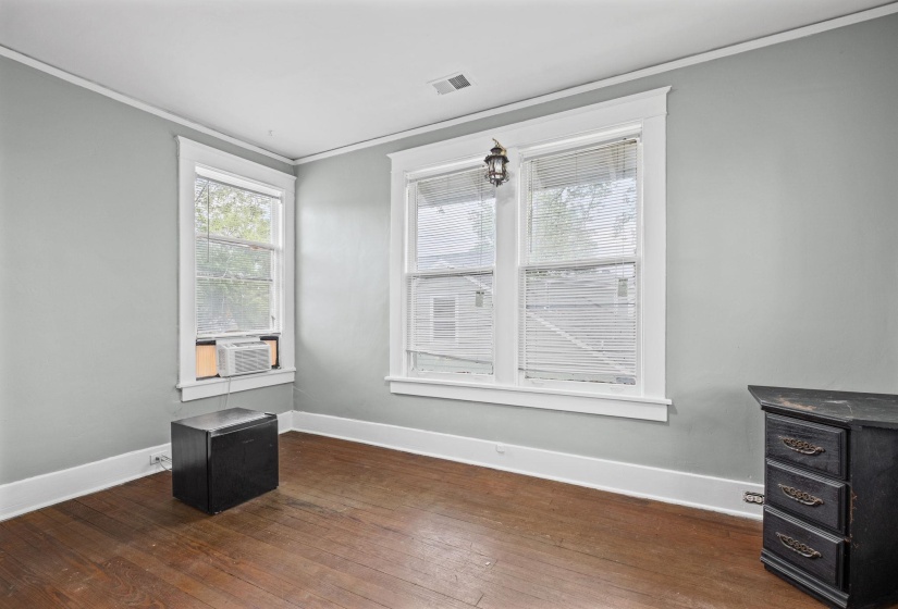 Hardwood flooring complemented by light gray walls and white trim