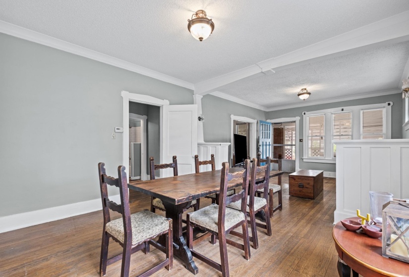 Spacious interior featuring wood-finish flooring, light gray wall paint, and white crown molding