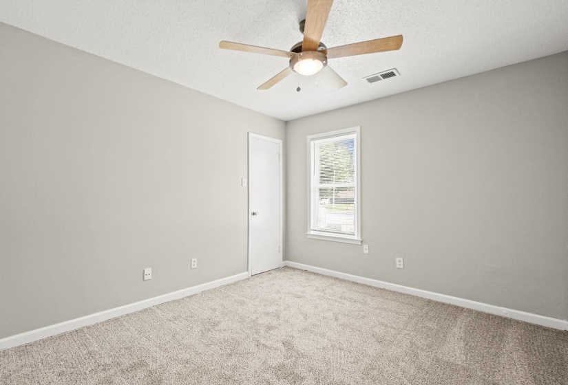 Carpeted room featuring a ceiling fan with integrated lighting, a single window, and light-toned wall paint