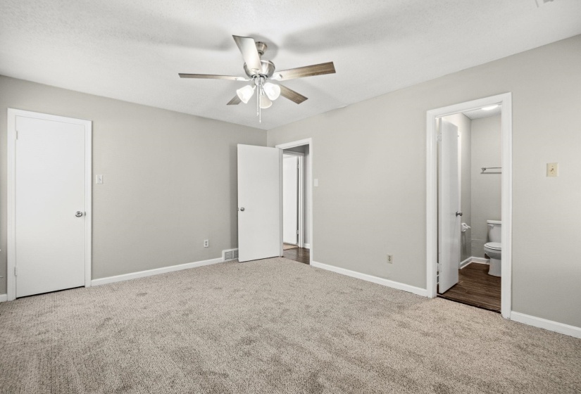 Carpeted interior room featuring light gray walls and white trim