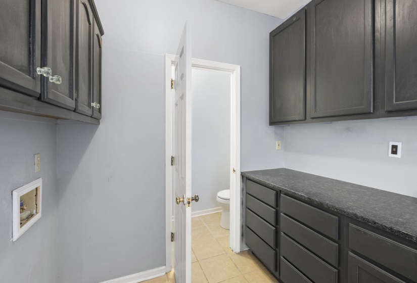 Laundry room featuring cabinet space, washer hookup, and light tile patterned flooring