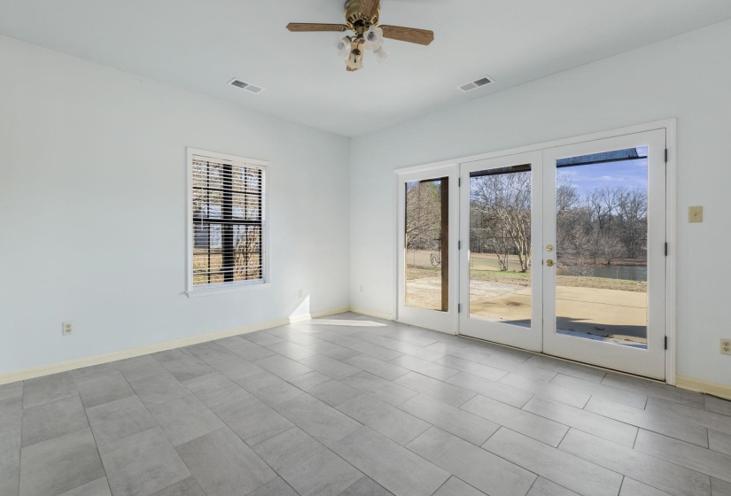 Empty room with french doors and a ceiling fan