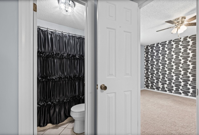 Bathroom with tiled flooring and a crystal flush mount light fixture