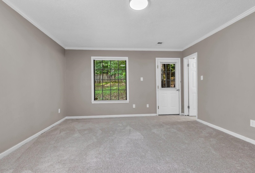 Neutral-toned walls complement the light gray carpeting