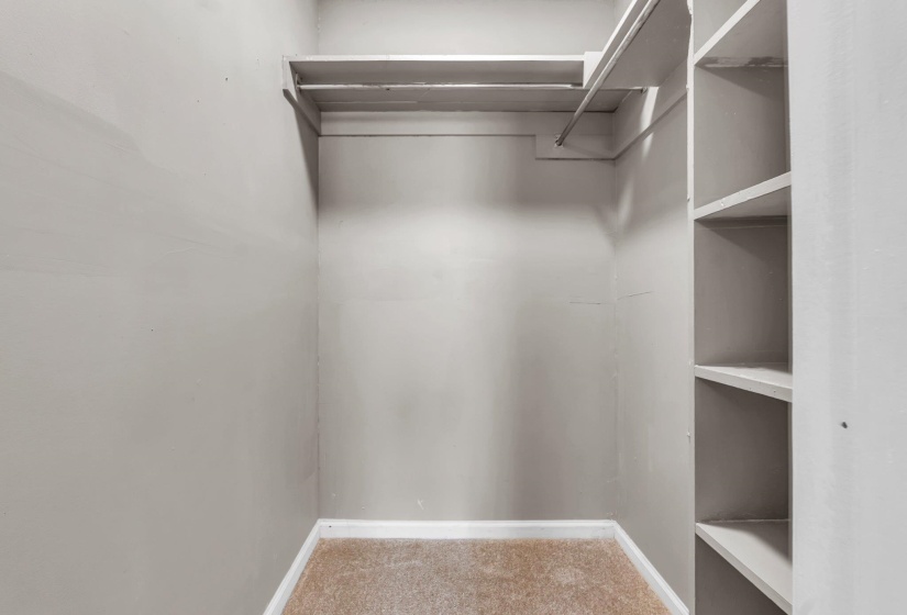 Recessed closet space featuring light grey wall finishes