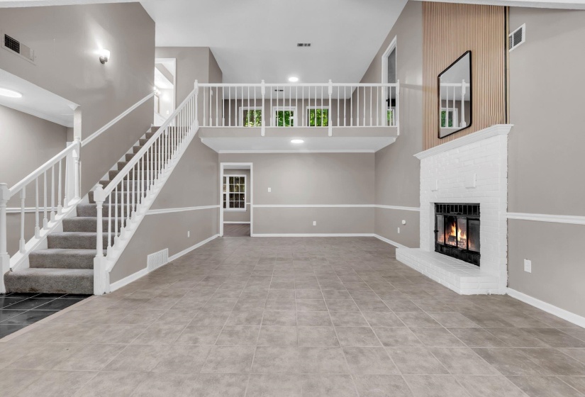 Spacious living area featuring a prominent white brick fireplace with an integrated firebox