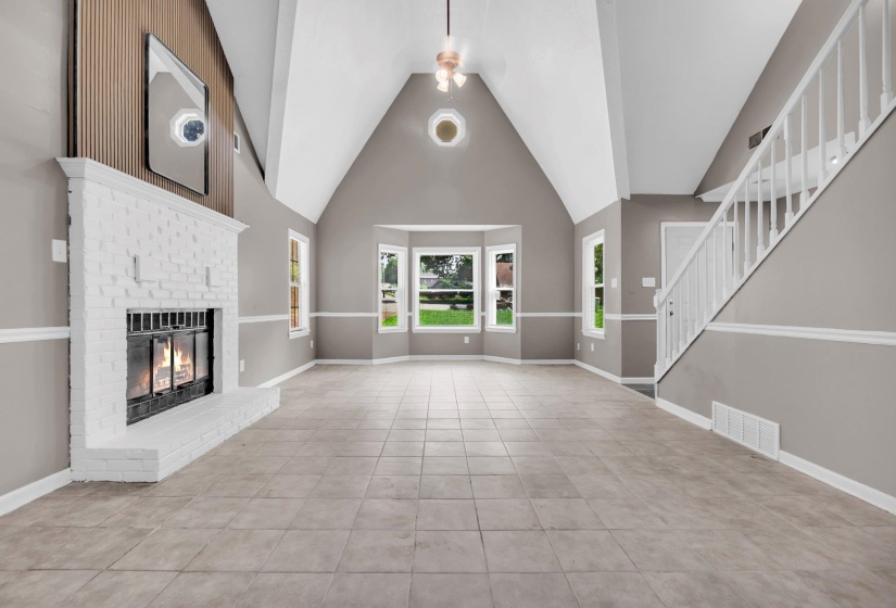 Vaulted ceilings with an angular design feature a suspended chandelier