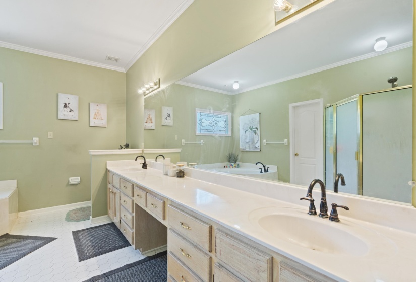 Dual vanity featuring white countertops, undermount sinks, and bronze-finish faucets