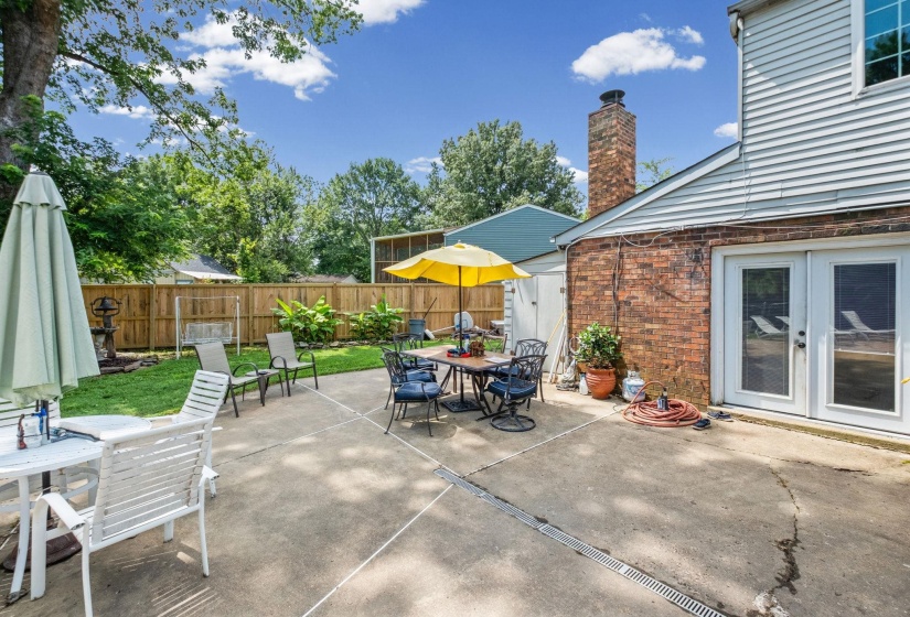 Spacious concrete patio featuring direct access to the interior via glass-paneled French doors