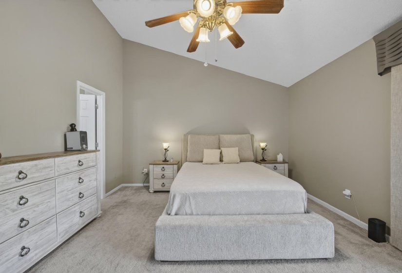 Vaulted ceiling featuring a ceiling fan with light fixture
