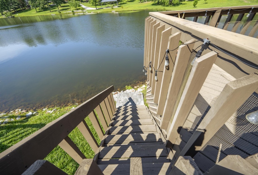 Stairway off the back deck leading to the water and grass area