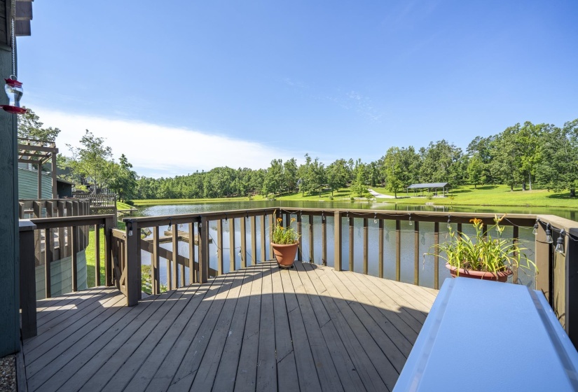 Expansive outdoor deck featuring wood-finish flooring and a full railing. Deck is off the living area