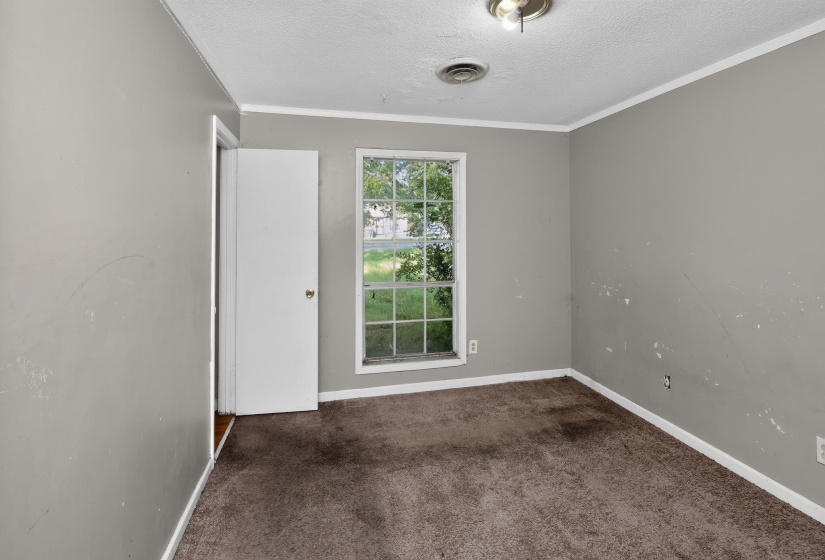 Room with a window and a white door