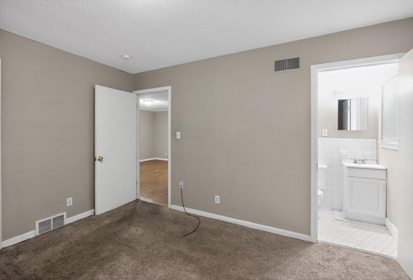 Room featuring neutral wall paint, carpet flooring, a white trim baseboard, and a ceiling-mounted light fixture