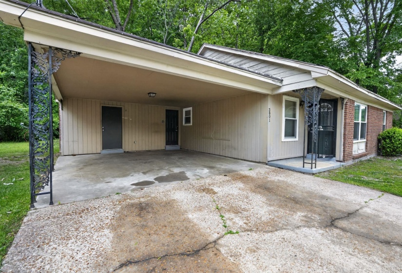 Single-story residence featuring a carport, brick exterior accents, and a covered front entry