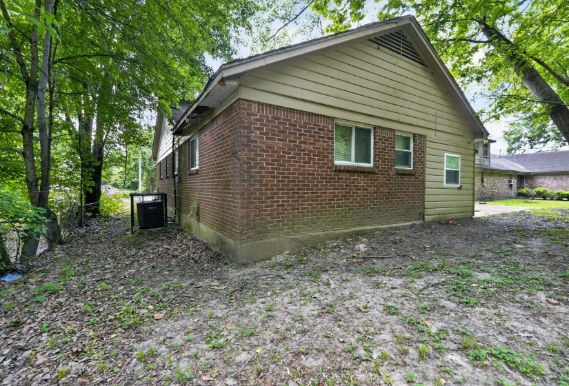 Brick and siding exterior with mature trees