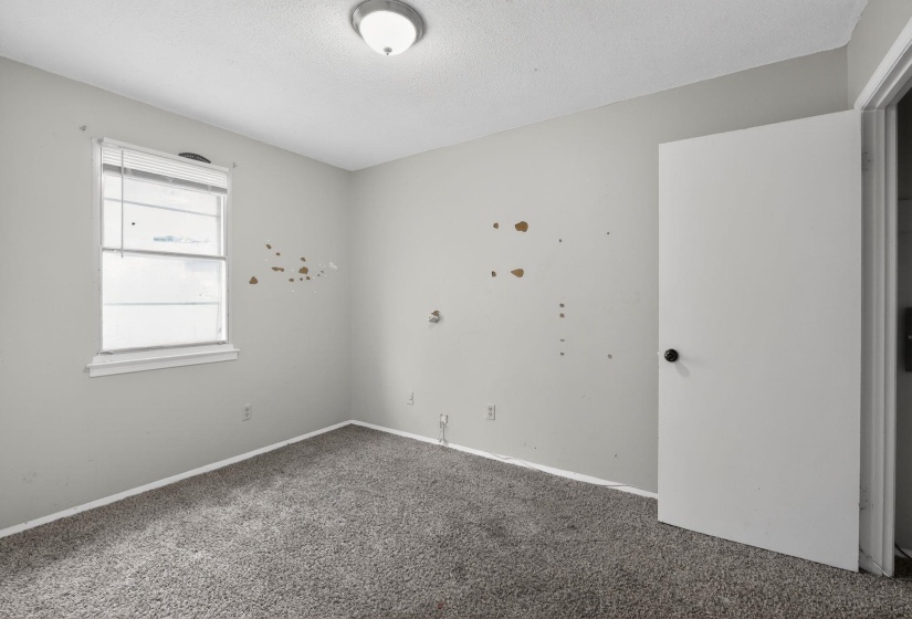 Spare room featuring carpet and a textured ceiling