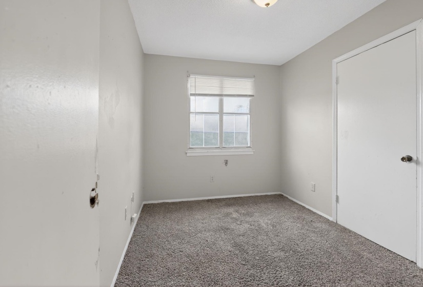 Unfurnished bedroom featuring carpet and baseboards
