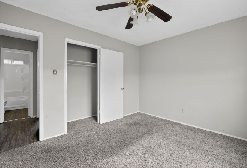 Unfurnished bedroom with carpet flooring, a closet, and ceiling fan