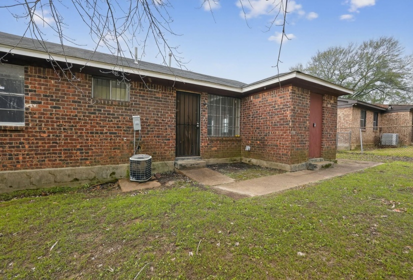 Rear view of house featuring brick siding