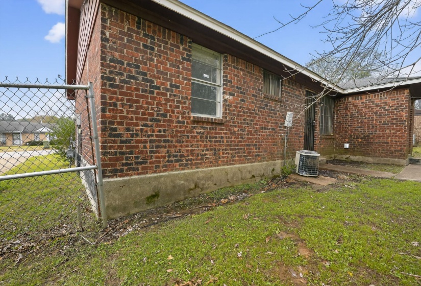 View of side of property featuring brick siding and a central AC unit