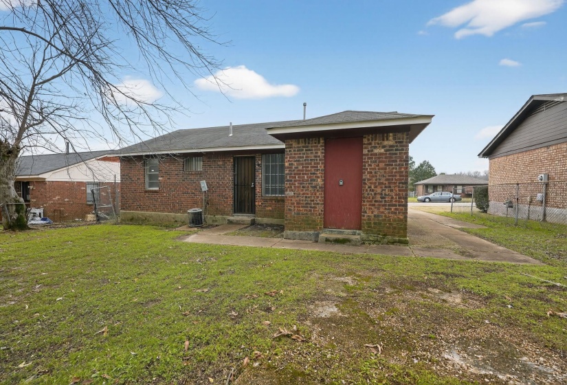 Back of house featuring brick siding