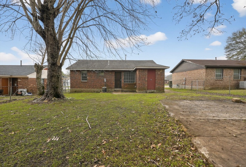 Back of house featuring brick siding