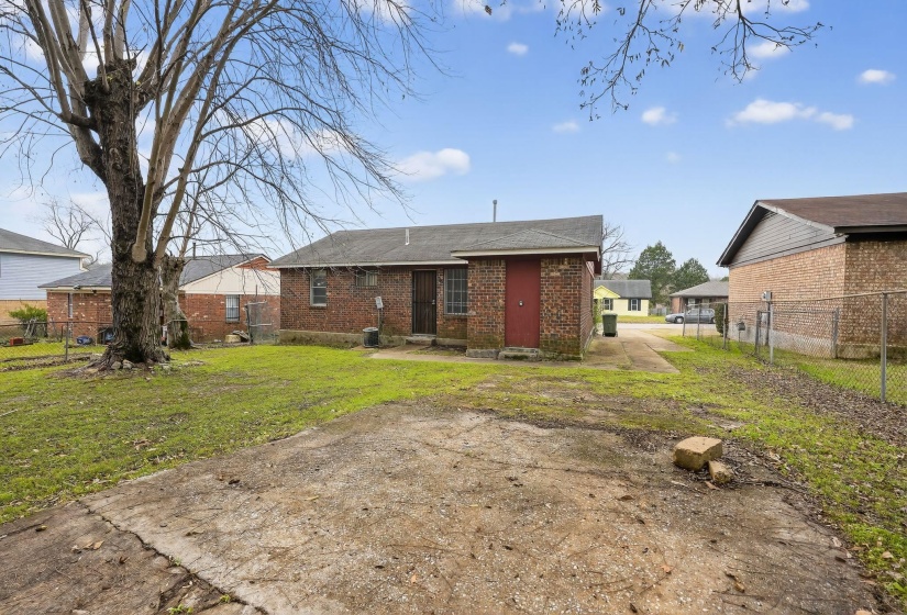 Back of property featuring brick siding