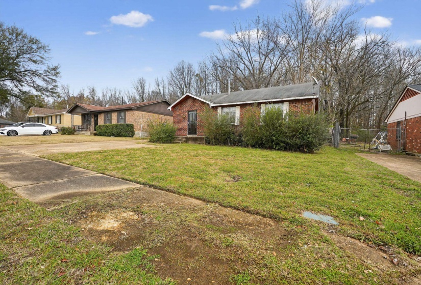 Single story home with brick siding and driveway