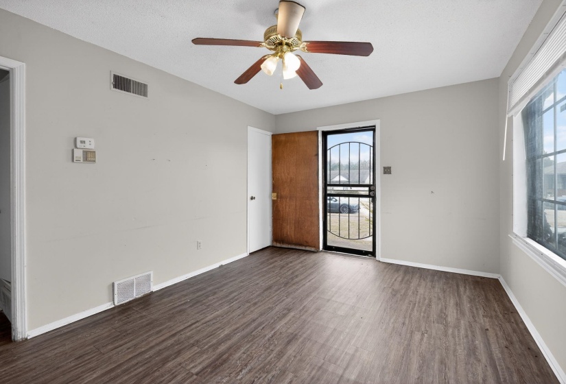 Spare room featuring dark wood-type flooring and a ceiling fan