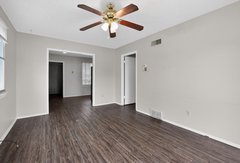 Empty room featuring dark wood-style floors and a ceiling fan