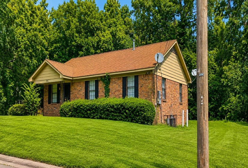 Brick exterior with a gabled roof and light-colored siding accents