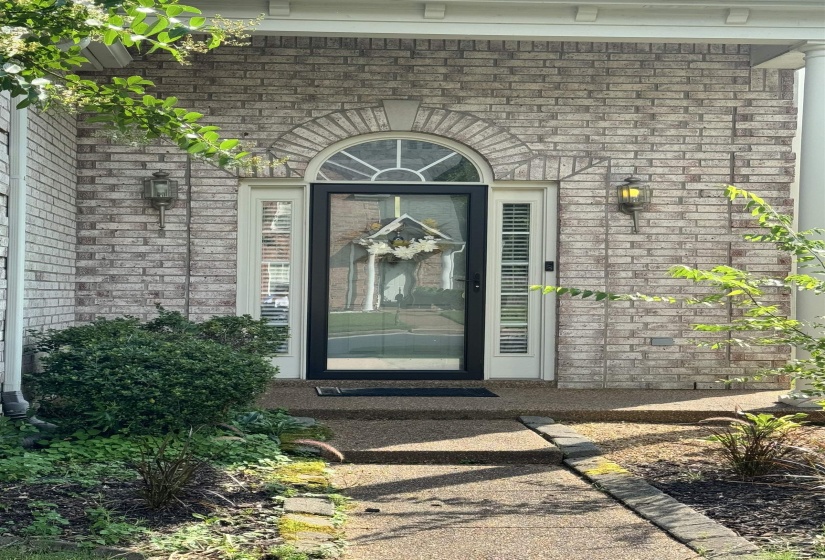 Brick facade featuring an arched transom window above the main entry