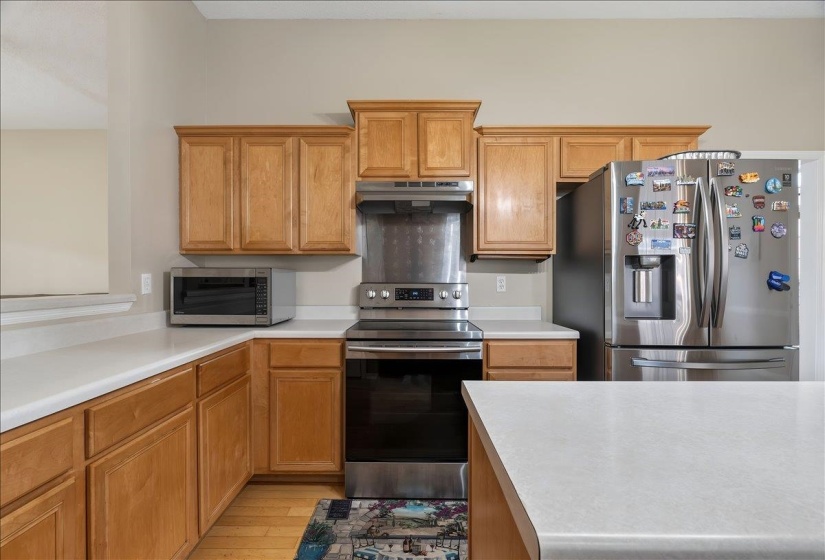 Light wood-finish cabinetry complemented by light-toned countertops