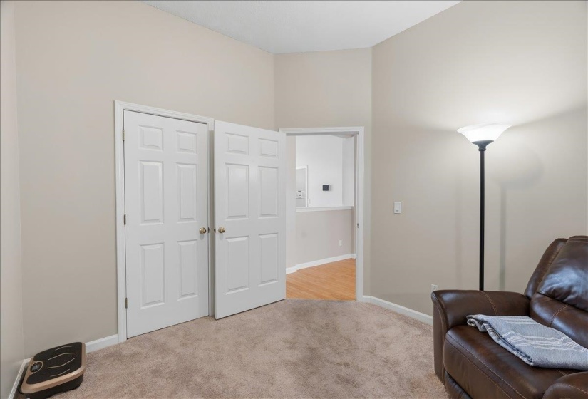 Neutral painted walls with white trim, two paneled doors, and plush carpet flooring