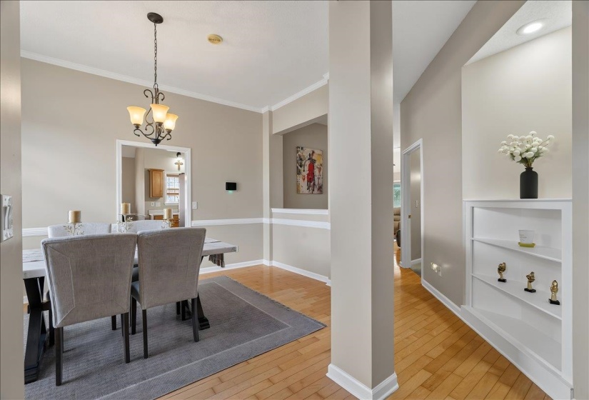 Dining area featuring a classic chandelier and wood-finish flooring