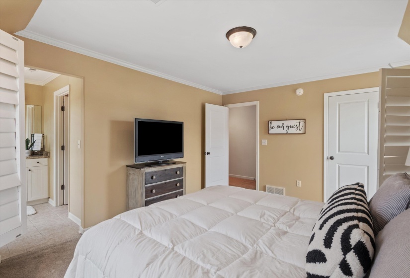 Bedroom with neutral painted walls and white trim