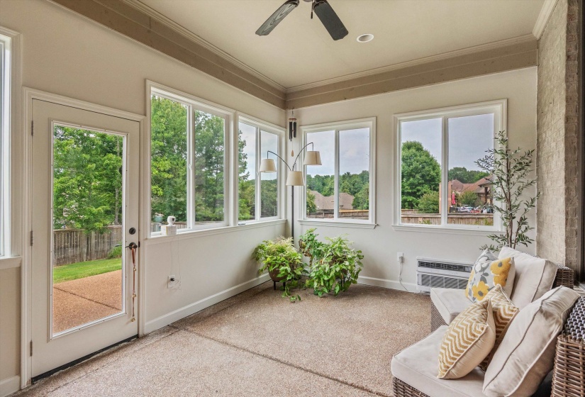 Sunroom with multiple windows, glass-paneled door, recessed lighting, and ceiling fan