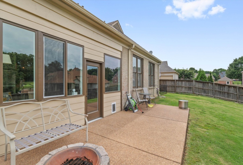 Expansive concrete patio with a built-in fire pit