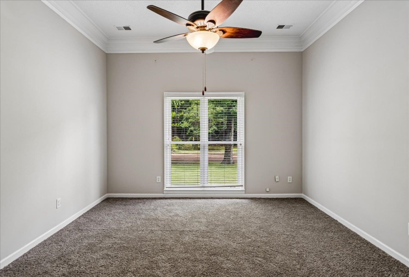 Recessed window with horizontal blinds framing a verdant exterior