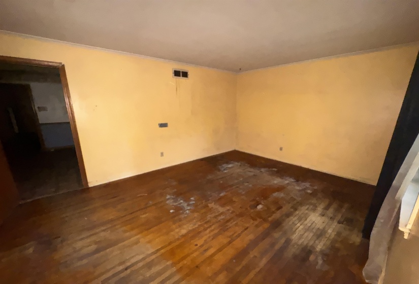 Interior room with wood-finish flooring and light-toned walls