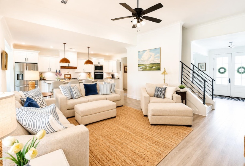 Open concept living space featuring wood-finish flooring