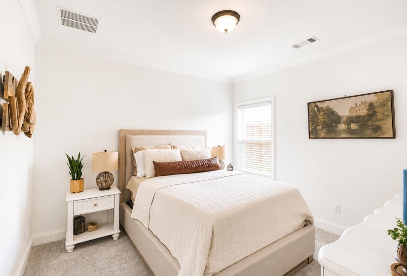 Bedroom featuring a window with blinds, light gray carpet, crown molding, and a flush-mount ceiling light