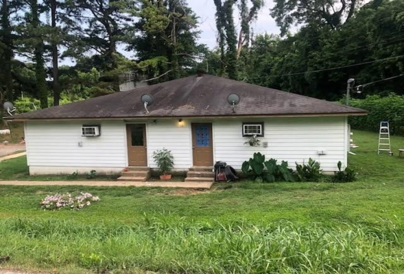 White siding exterior with a dark shingle roof