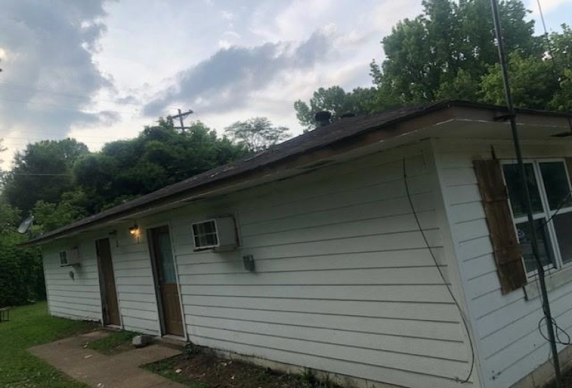 White siding exterior with a dark shingle roof